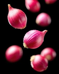 Poster - Onion Cloves Suspended in Mid Air Against a Sleek Black Background for Ecommerce Showcase
