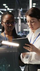 Poster - vertical video teamworking engineers in data center integrate ai automation tools together during ma