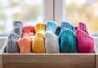 © Selsi - Colorful knitted socks neatly folded in a wooden box