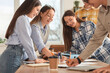© Pixel-Shot - Young business people negotiating at table in office