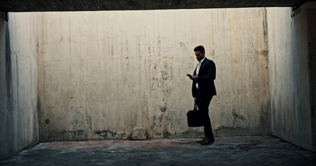 Aufkleber - Business, phone and space with man by concrete wall for communication or networking. Application, social media or text message and person with briefcase on mockup for data, information or update
