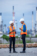 © Kalyakan - Industrial engineer discuss project strategy industrial oil refinery site digital technology, Teamwork engineer innovation collaborating energy facility digital technology oil refinery, Smart industry