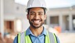 © ahmad zaenal - Smiling construction worker wearing hard hat and safety vest at construction site