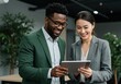 © stock.metket.com - Two business colleagues are working together looking at a tablet in the office environment