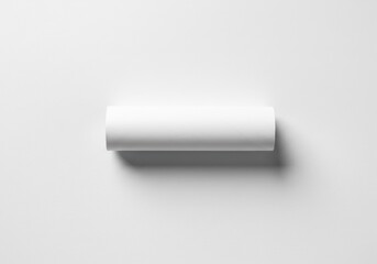 Poster - A white cardboard tube is lying on a white textured surface in a studio setting
