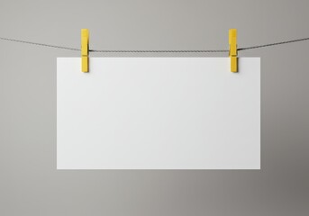 Poster - Blank white paper hanging from a rope with yellow clothespins against a gray background