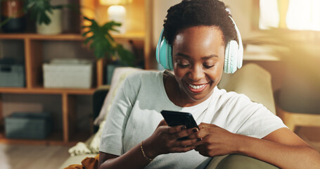 Aufkleber - Headphones, black woman and happy with phone on sofa for streaming subscription, music playlist and search song. Relax, person and smartphone for social media video and listening to podcast in home