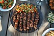 © Vlad - Turkish Food. Traditional Middle Eastern Dinner Table with Grilled Lamb Kebab, Chicken Skewers, and Roasted Vegetables