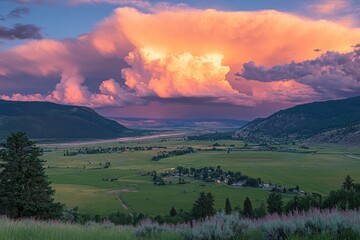 Wall Mural - vibrant pink sunset lights over a lush green valley between two mountain ranges. use for nature, tra