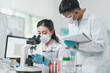 © chokniti - Medical science research team in modern laboratory conducting experiments, analyzing samples under microscopes, developing innovative solutions for healthcare technology