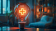 © Alex Alex - A close-up of a light bulb with a glowing yellow cross inside. The idea of health, energy and innovation.