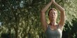 © doo - Relaxed Yoga Practice in Forest is a premium-quality stock image ideal for use in lifestyle blogs, health content, promotional campaigns, and editorial publications.
