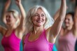 © Igor - Active middle-aged women dancing joyfully in gym class