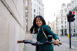 © Westend61 - Businesswoman commuting on an electric scooter in London city street