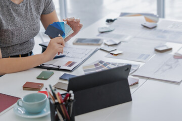 Fototapete - Architects interior designer hands working with Blueprints and documents for a home renovation for house design