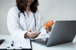 © Orathai - The female doctor sat and checked the patient's history and used a laptop to record patient information at the hospital. Medical concepts and interests