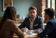 © ABDUS - Business Colleagues Having a Discussion at a Table