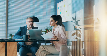 Poster - Paperwork, laptop and business people in office with meeting for company investment deal. Computer, documents and finance manager with investor client for discussion with dividend report in workplace