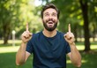 © all is well - Excited man pointing upwards in park for advertisement, presentation, or promotion use