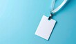 © Olga Gorkun - A blank white identification badge with a lanyard on a blue background represents corporate identity, access control, and professional environments