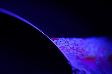 Poster - Deep blue liquid surface on black background, oil stains movement, bright chemistry, surreal background, deep galaxy atmosphere 