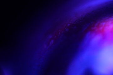 Poster - Deep violet liquid surface on black background, oil stains movement, bright chemistry, surreal background, deep galaxy atmosphere 