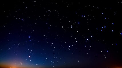 Wall Mural - star trails on dark blue night sky, time lapse captures celestial motion of stars in cosmos over tim