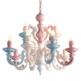 Ornate chandelier with pastel pink and blue accents isolated on a transparent background