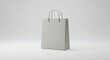 © João Salgado - A blank gray shopping bag is standing alone on a white background in a studio setting.