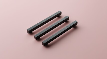 Poster - Three sleek black geometric shapes rest on a soft pink background, showcasing modern design and clean lines that enhance contemporary aesthetics