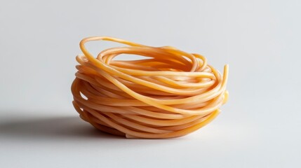 Poster - A nest-like pile of uncooked pasta on a white background.