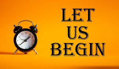 Wall Mural - let us begin symbol. concept word let us begin on beautiful orange background with alarm clock. busi