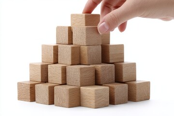 Poster - Building a Successful Foundation - Hand placing wooden block on top of a pyramid structure, symbolizing growth and achievement