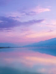 Wall Mural - Serene Twilight Reflections Over Calm Water with Soft Pink and Purple Skies and Silhouette of Mountains in the Distance