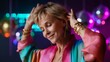 © O - Joyful attractive smiling mature woman dancing at a party with colorful disco ball lights background. Celebration of life and freedom concept at night.