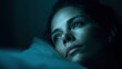 © Lumi_Studio - Blue-toned conceptual image of a sleepless woman lying in bed, staring at the ceiling with a blank expression, dark bedroom setting, minimalism and emotional depth for stock editorial use