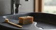 © diditlagi - Two Beige Herbal Soap Bars and Bamboo Toothbrush on Grey Sink