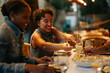 © bernardbodo - Friends sharing food at a restaurant table, enjoying a meal together