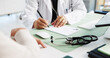 © BuyOutFelix02/peopleimages.com - Patient, hands and doctor writing prescription in consultation for medical diagnosis, healthcare service or sick note. Closeup, person or health worker with script in clinic for treatment information