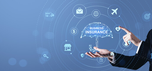 Poster - Business insurance concept with digital umbrella and icons in blue futuristic interface held by businessman hand on abstract background.