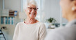 © BuyOutFelix02/peopleimages.com - Physiotherapy, smile and senior woman in office, conversation and help with feedback. Professional, medical and elderly patient with appointment, recovery and healing with discussion and healthcare