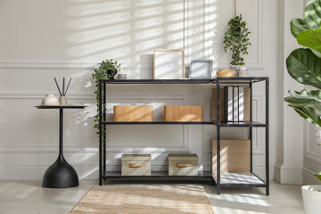 Poster - Console table with different decor near white wall indoors. Interior design