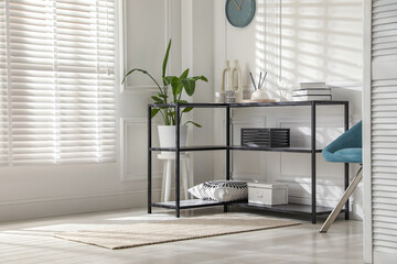 Poster - Console table with different decor near white wall indoors. Interior design