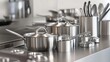 © Bassmallah - Stainless steel cookware set on modern kitchen counter.