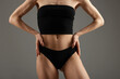 © New Africa - Woman with perfect slim body on grey background, closeup