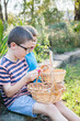© Austockphoto - Two boys sitting eating chocolate eggs after Easter egg hunt