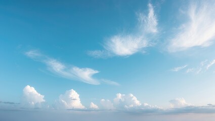 Poster - Marvel at the wide, bright blue sky merging with soft white clouds, showcasing a natural and serene atmosphere.