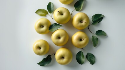 Aufkleber - Numerous fresh yellow apples on a white background, overhead view