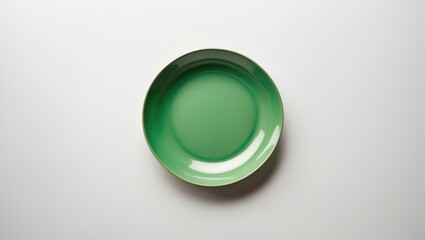 Poster - White background featuring an empty cup or bowl made of green ceramic from above