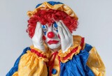 The image features a clown screaming, isolated on a plain white backdrop